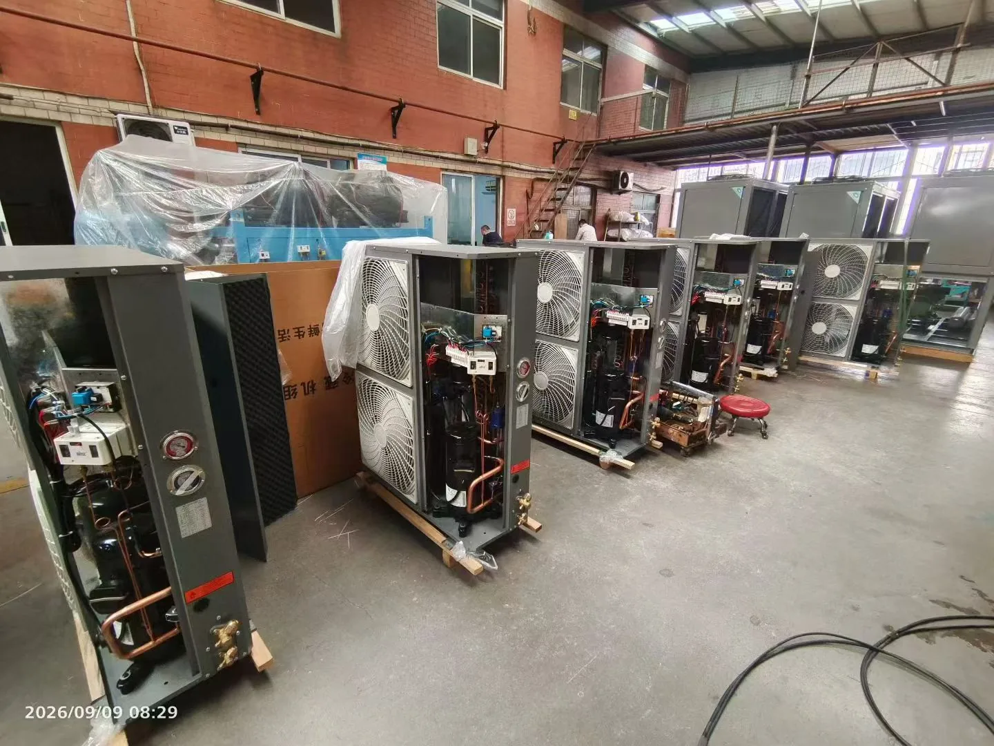 Refrigeration units being assembled in a workshop
