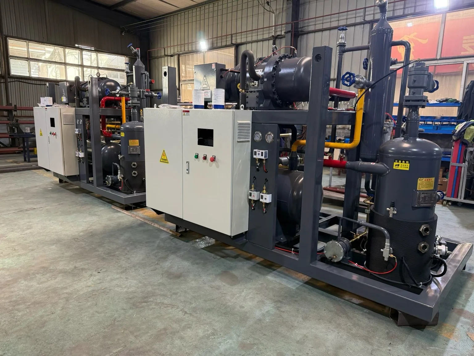 Packaged refrigeration units lined up in a factory